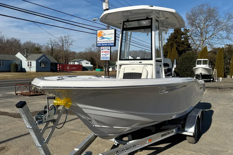 Slide: The Image of 2026 Tidewater 210 CC Adventure boat on trailer at dealership, sunny day. - 8