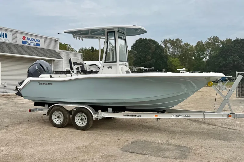 The Image of 2026 Tidewater 210 LXF boat on trailer, parked near marine service center. - 0
