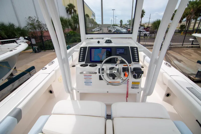 Slide: The Image of 2023 Robalo 246 Cayman boat cockpit with steering wheel and navigation display. - 18