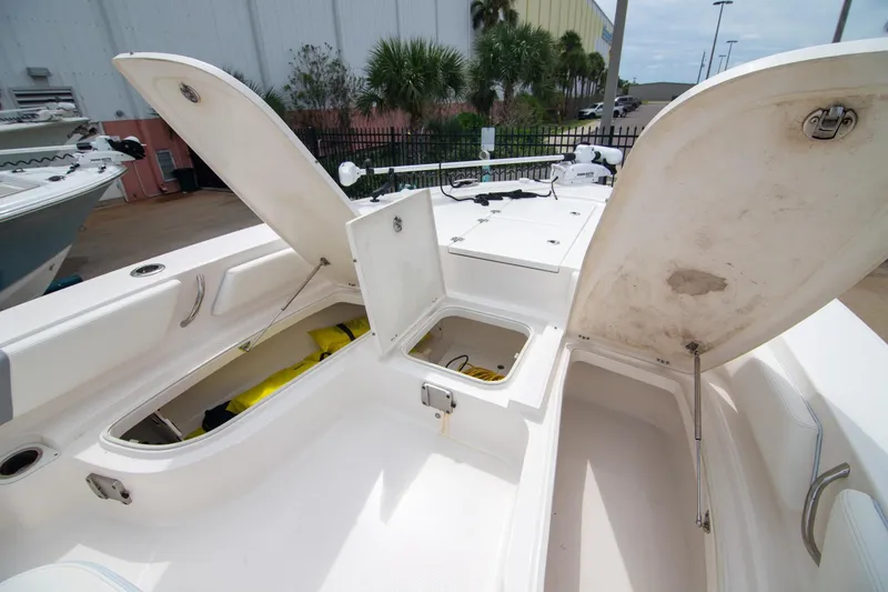 Slide: The Image of 2023 Robalo 246 Cayman boat storage compartments open, showcasing spacious interior design. - 20