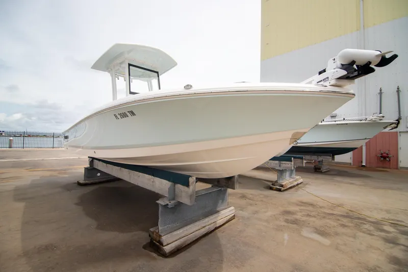 Slide: The Image of 2023 Robalo 246 Cayman boat on dry dock, side view. - 4
