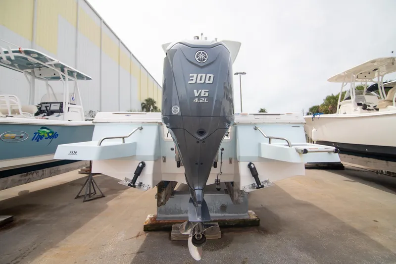 Slide: The Image of 2023 Robalo 246 Cayman boat with Yamaha 300 V6 engine, docked outdoors. - 5