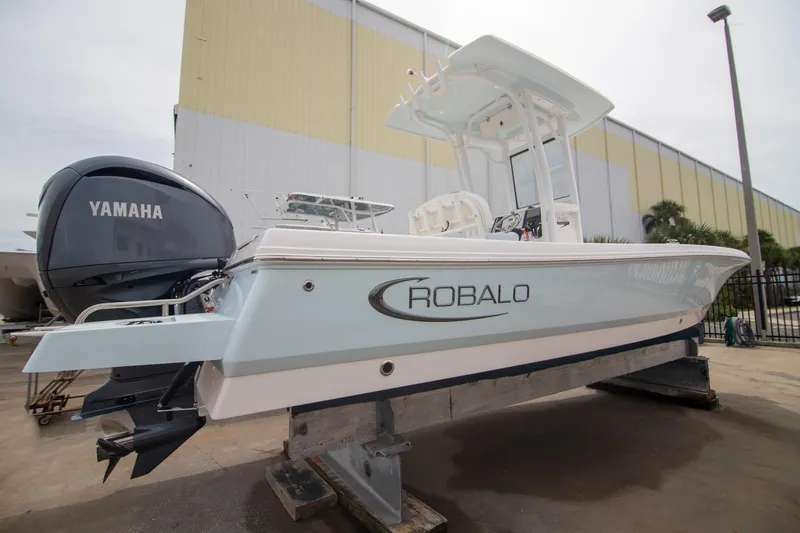 Slide: The Image of 2023 Robalo 246 Cayman boat with Yamaha engine, displayed outdoors. - 7