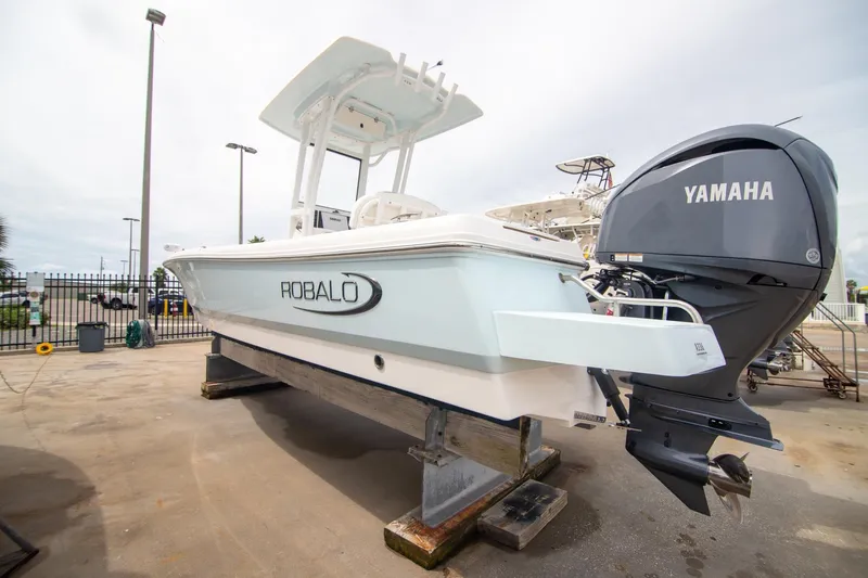Slide: The Image of 2023 Robalo 246 Cayman boat with Yamaha engine on display at a marina. - 8