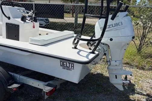 Slide: The Image of 2025 Delta Boatworks D18 with Suzuki outboard motor, parked on a trailer. - 3