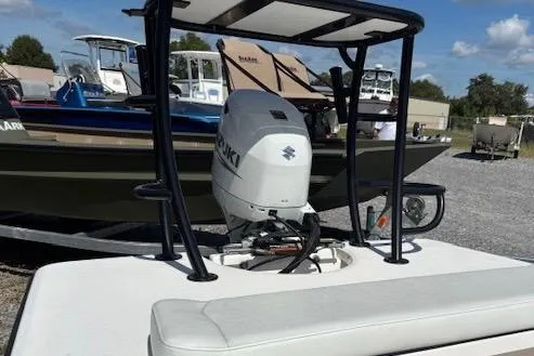 Slide: The Image of 2025 Delta Boatworks D18 with Suzuki outboard motor, docked in a marina. - 5