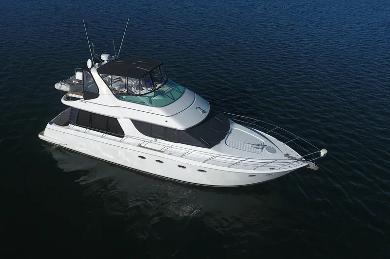 The Image of 1998 Carver 530 Voyager Pilothouse yacht cruising on open water. - 0