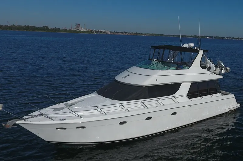 Slide: The Image of 1998 Carver 530 Voyager Pilothouse yacht cruising on open water. - 1