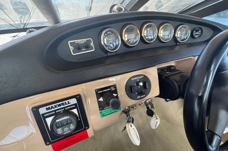 Slide: The Image of Control panel of a 1998 Carver 530 Voyager Pilothouse with gauges and switches. - 13