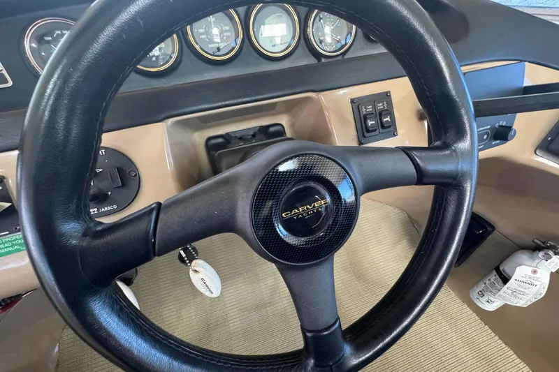 Slide: The Image of Steering wheel of 1998 Carver 530 Voyager Pilothouse with dashboard instruments. - 14