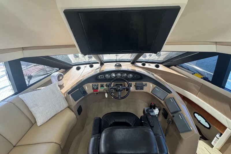 Slide: The Image of 1998 Carver 530 Voyager Pilothouse helm with leather seating and modern controls. - 15