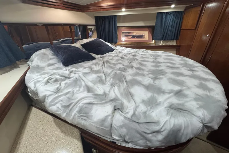 Slide: The Image of Luxurious bedroom interior of 1998 Carver 530 Voyager Pilothouse yacht with plush bedding. - 18
