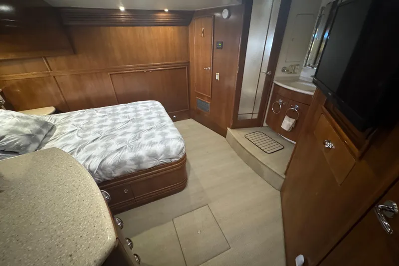 Slide: The Image of Interior of 1998 Carver 530 Voyager Pilothouse with bed, wood paneling, and bathroom. - 26