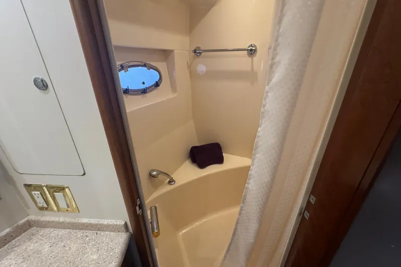 Slide: The Image of Shower area in 1998 Carver 530 Voyager Pilothouse with porthole and curtain. - 27
