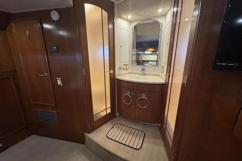 Slide: The Image of Luxurious 1998 Carver 530 Voyager Pilothouse bathroom with wood accents and modern fixtures. - 29