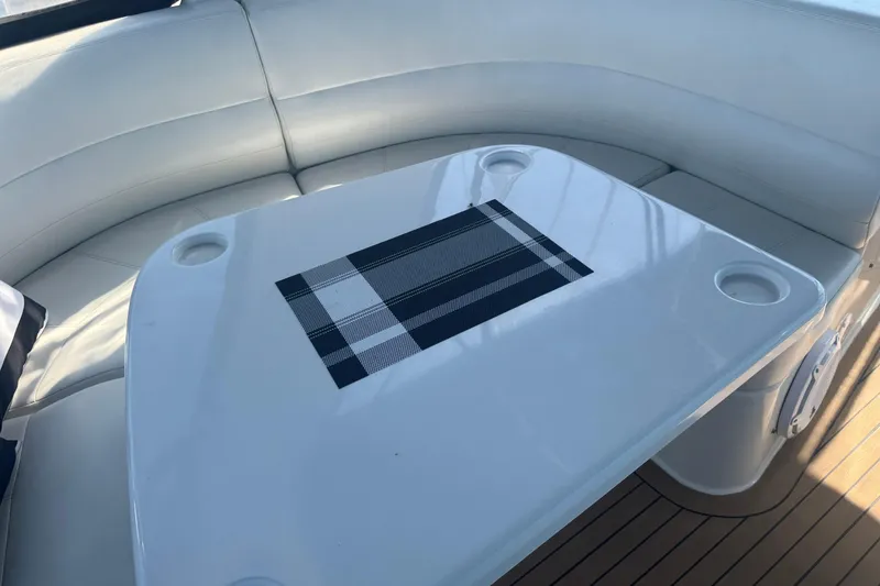 Slide: The Image of Interior seating area of 1998 Carver 530 Voyager Pilothouse with a sleek table. - 44