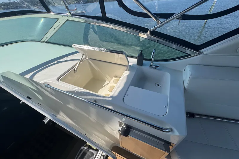 Slide: The Image of 1998 Carver 530 Voyager Pilothouse interior with sink and storage compartment. - 49