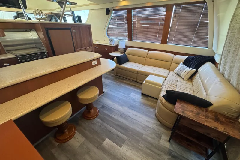 Slide: The Image of Luxurious interior of 1998 Carver 530 Voyager Pilothouse with beige seating and modern kitchen. - 67
