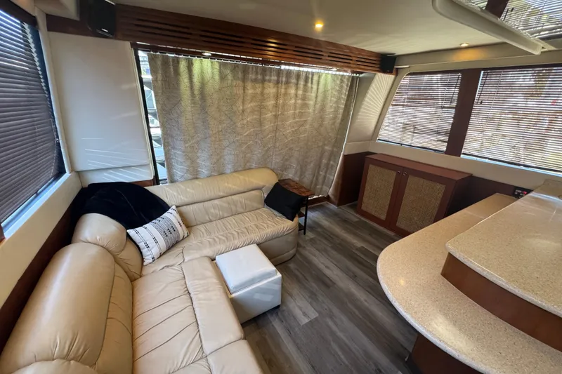 Slide: The Image of Luxurious interior of 1998 Carver 530 Voyager Pilothouse with beige leather seating and wood accents. - 68