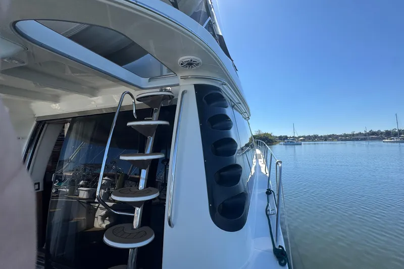 Slide: The Image of 1998 Carver 530 Voyager Pilothouse yacht with spiral staircase, docked on a sunny day. - 70