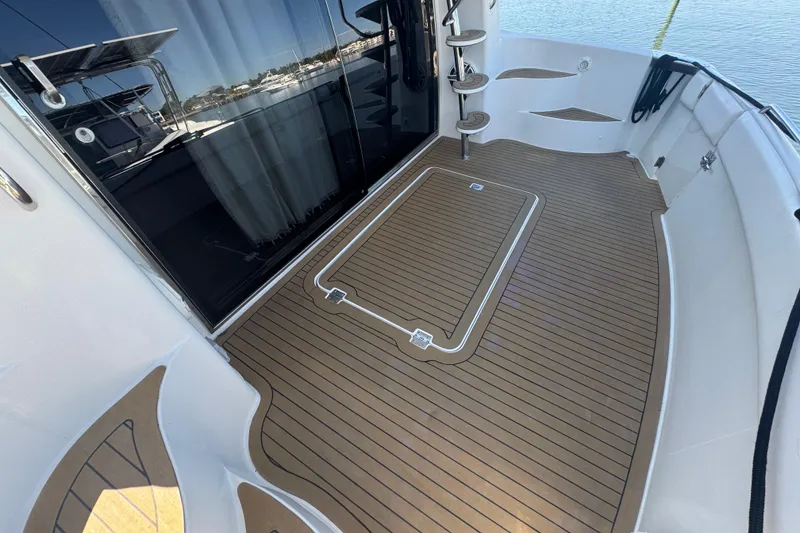 Slide: The Image of 1998 Carver 530 Voyager Pilothouse yacht deck with teak flooring and modern design. - 76