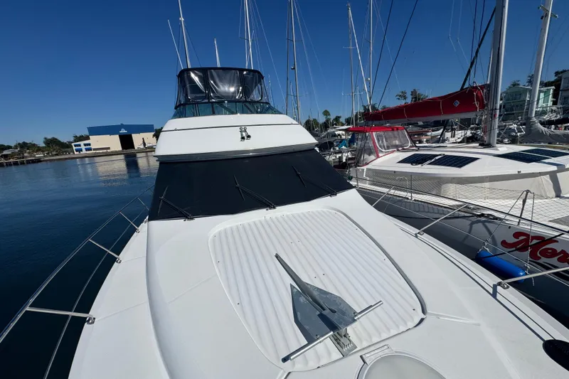 Slide: The Image of 1998 Carver 530 Voyager Pilothouse yacht docked at marina, clear blue sky. - 79