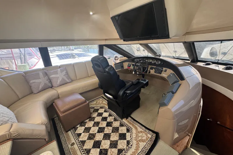 Slide: The Image of Luxurious 1998 Carver 530 Voyager Pilothouse interior with helm, leather seating, and elegant decor. - 8