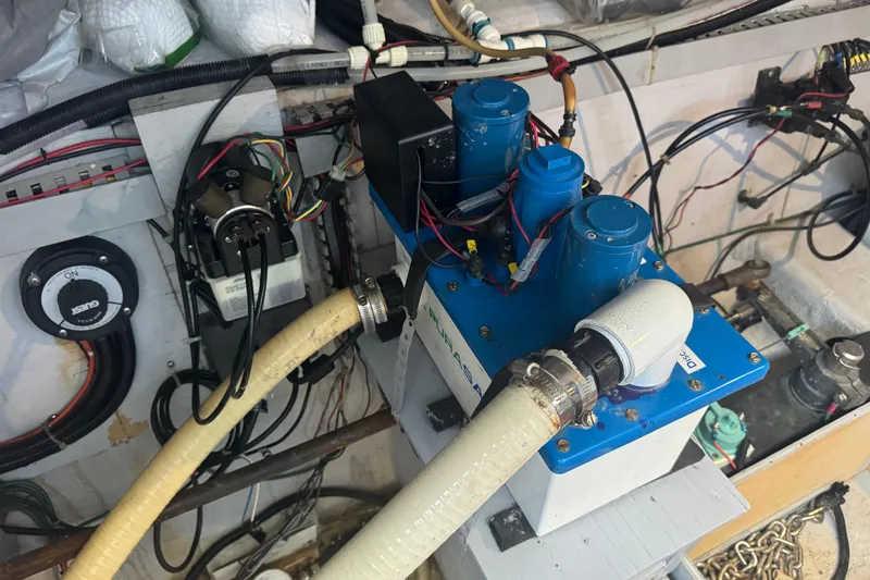 Slide: The Image of Engine room of a 1998 Carver 530 Voyager Pilothouse with mechanical components and wiring. - 85