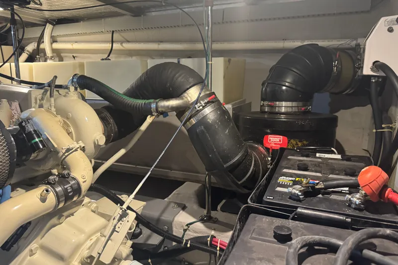 Slide: The Image of Engine room of a 1998 Carver 530 Voyager Pilothouse with visible components and battery. - 94