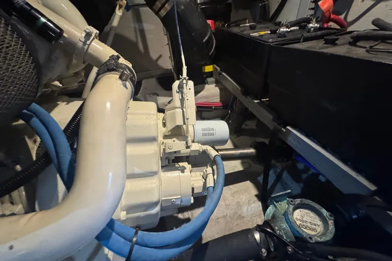 Slide: The Image of Engine room of 1998 Carver 530 Voyager Pilothouse with visible components and hoses. - 96