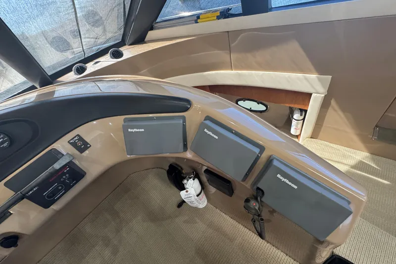 Slide: The Image of 1998 Carver 530 Voyager Pilothouse helm with Raytheon navigation displays and controls. - 10