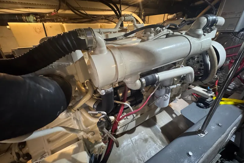 Slide: The Image of Engine room of 1998 Carver 530 Voyager Pilothouse, showcasing detailed mechanical components. - 100