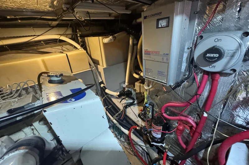 Slide: The Image of Engine room of 1998 Carver 530 Voyager Pilothouse with electrical components and wiring. - 104