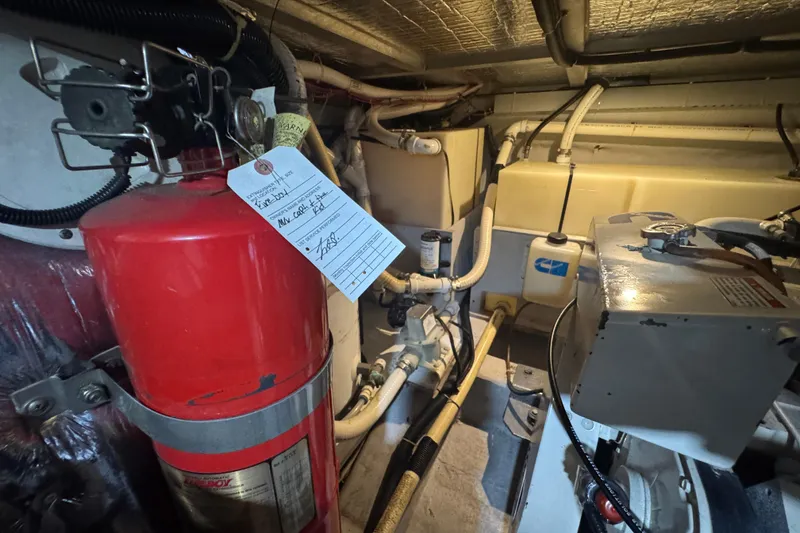 Slide: The Image of Engine room of 1998 Carver 530 Voyager Pilothouse with fire extinguisher and equipment. - 105