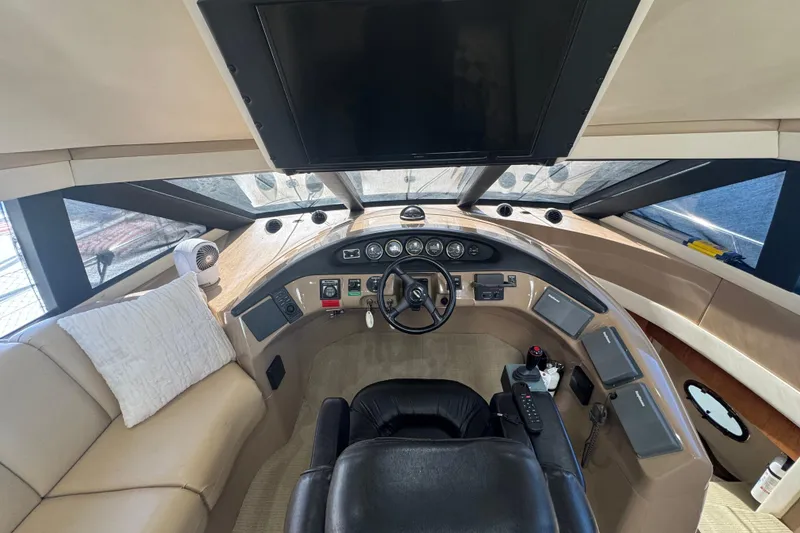 Slide: The Image of 1998 Carver 530 Voyager Pilothouse helm with leather seating and modern controls. - 11