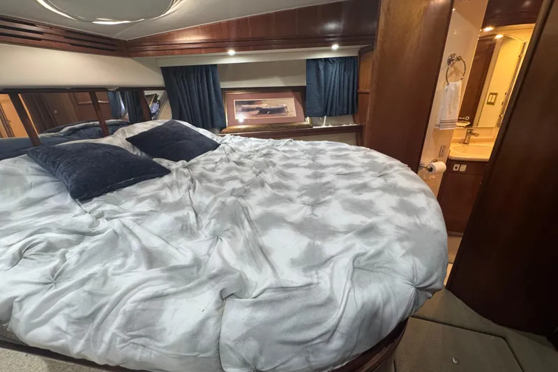Slide: The Image of Luxurious bedroom interior of 1998 Carver 530 Voyager Pilothouse yacht with plush bedding. - 19