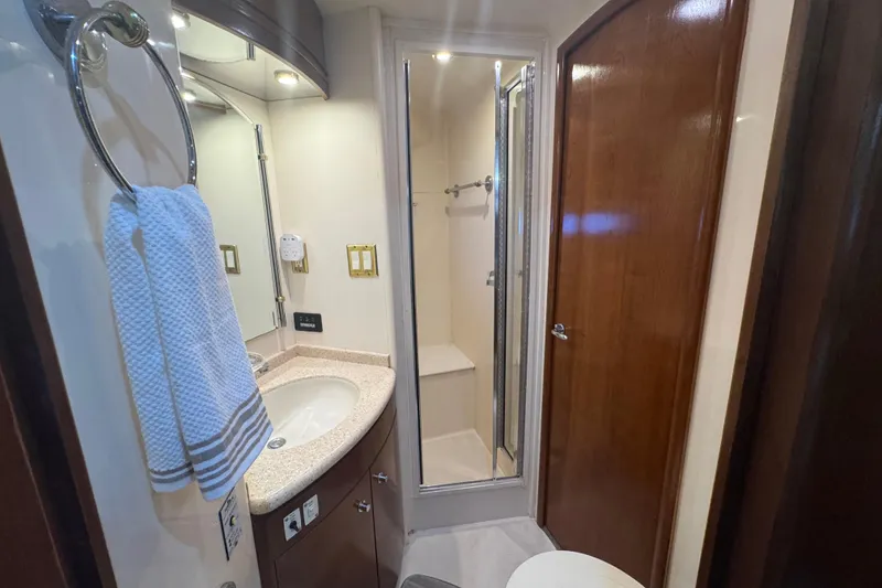Slide: The Image of Bathroom interior of 1998 Carver 530 Voyager Pilothouse with sink, shower, and wooden door. - 21
