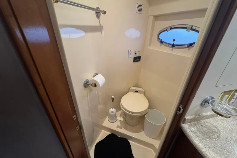 Slide: The Image of Bathroom in 1998 Carver 530 Voyager Pilothouse yacht with porthole and toilet. - 28