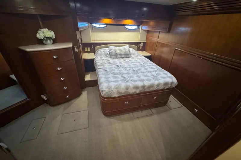 Slide: The Image of Luxurious bedroom interior of 1998 Carver 530 Voyager Pilothouse yacht with wood paneling. - 30