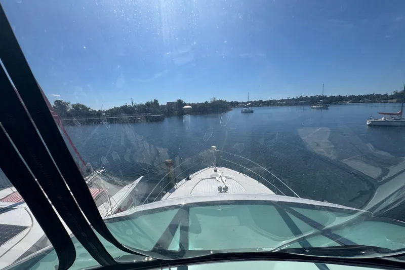 Slide: The Image of View from 1998 Carver 530 Voyager Pilothouse, overlooking calm waters and distant shoreline. - 52
