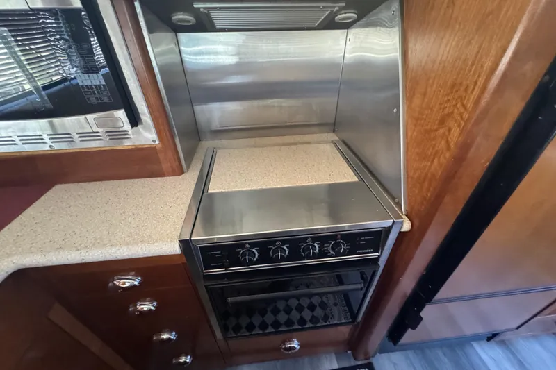 Slide: The Image of 1998 Carver 530 Voyager Pilothouse kitchen with stove and countertop. - 63