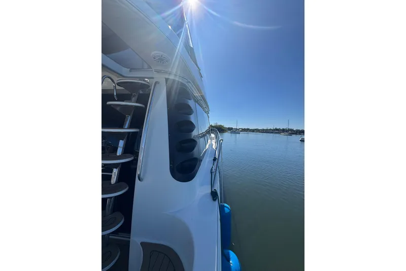 Slide: The Image of 1998 Carver 530 Voyager Pilothouse yacht on calm water under clear blue sky. - 71