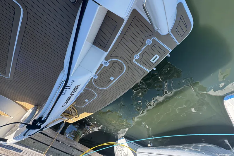 Slide: The Image of 1998 Carver 530 Voyager Pilothouse docked, showcasing sleek deck design and water reflection. - 74