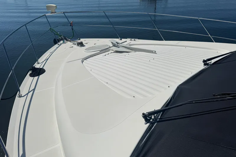 Slide: The Image of 1998 Carver 530 Voyager Pilothouse yacht deck with railing and anchor. - 77