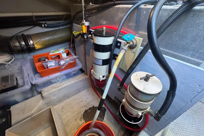 Slide: The Image of Engine room of 1998 Carver 530 Voyager Pilothouse with fuel filters and maintenance tools. - 86