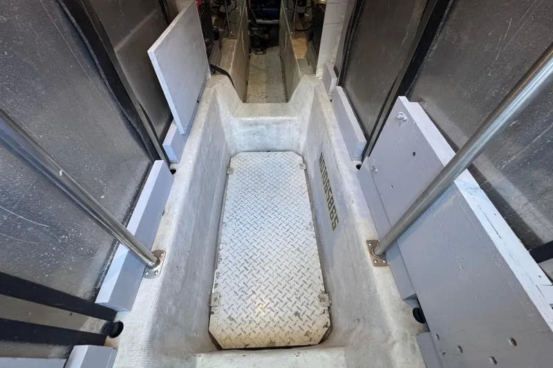 Slide: The Image of Engine room access of 1998 Carver 530 Voyager Pilothouse with metal flooring. - 87