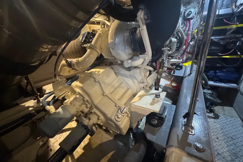 Slide: The Image of Engine room of 1998 Carver 530 Voyager Pilothouse, showcasing mechanical components and piping. - 88