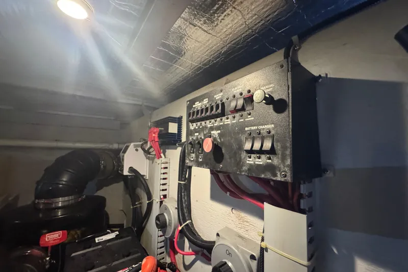 Slide: The Image of Electrical panel in 1998 Carver 530 Voyager Pilothouse engine room, featuring switches and wiring. - 90