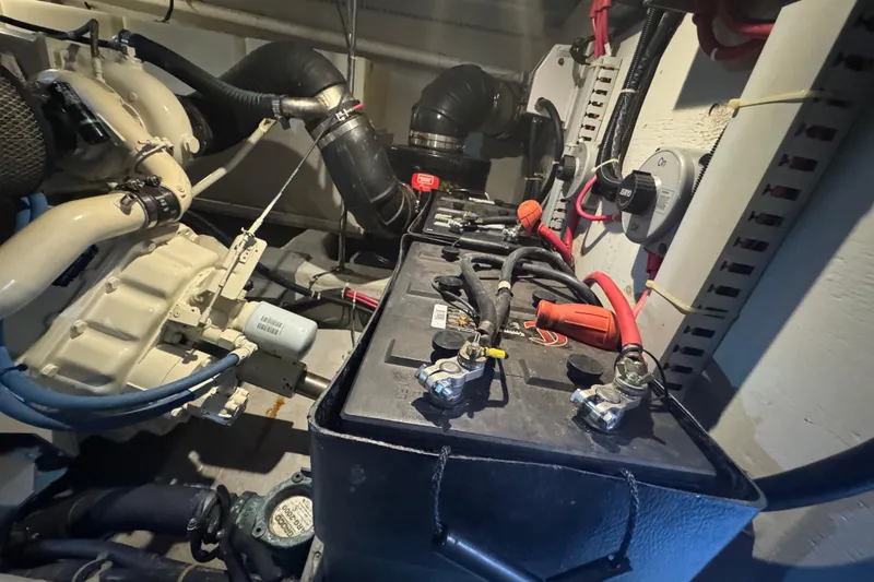 Slide: The Image of Engine room of 1998 Carver 530 Voyager Pilothouse with battery and wiring. - 91