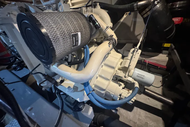 Slide: The Image of Engine compartment of a 1998 Carver 530 Voyager Pilothouse, featuring mechanical components and hoses. - 97